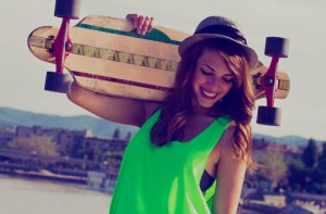 teen smiling holding skateboard