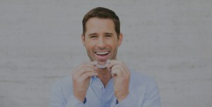 Man holding Invisalign tray