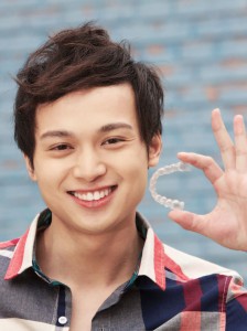 Boy-smiling-holding-Invisalign-tray-in-brooklyn