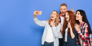 Smiling teens taking selfie
